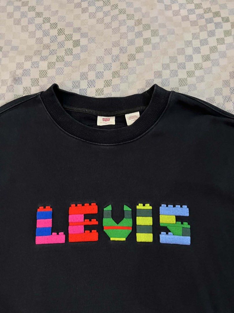 Levi's x LEGO Black Sweatshirt (Category: Coats, Jackets and Outerwear) located in Batangas. Submitted by gavsandrix (Listing ID 1445422396, Image 2). Description: - Black Levi's sweatshirt - Fun LEGO-inspired logo graphic - Crew neck, long sleeves - Made in China - Ideal for casual wear - Please check photos for detailed condition.
