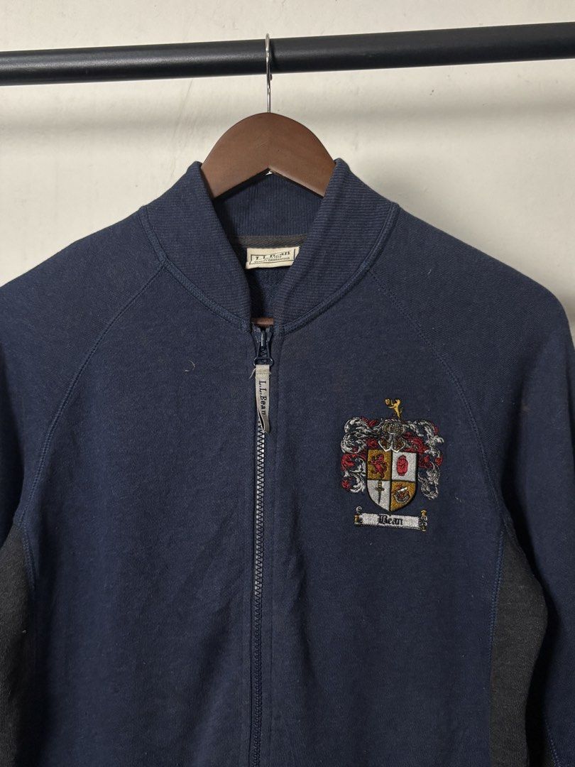 l.l.bean Navy Blue Crest Zip-Up Jacket XS (Category: Coats, Jackets and Outerwear) located in Manila. Submitted by angelll444 (Listing ID 1445476815, Image 2). Description: - Medium 21x27 - Navy blue L.L.Bean zip-up jacket - Embroidered crest on chest - Dark grey side panels - Two front pockets - Ribbed collar, cuffs, and hem - Ideal for casual wear.