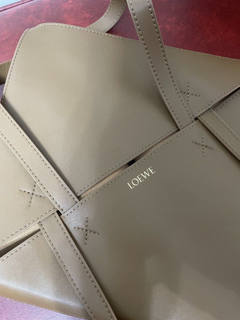 Loewe Brown Leather Geometric Tote Bag (Category: Luxury Bags & Wallets) located in Quezon City. Submitted by sheen_calanza (Listing ID 1445570445, Image 3). Description: - Authentic Loewe brown leather tote bag - Unique geometric design on the front - Simple and chic style - Spacious interior for daily essentials - Two comfortable top handles - Gold Loewe logo embossed inside - Thrifted in Japan .