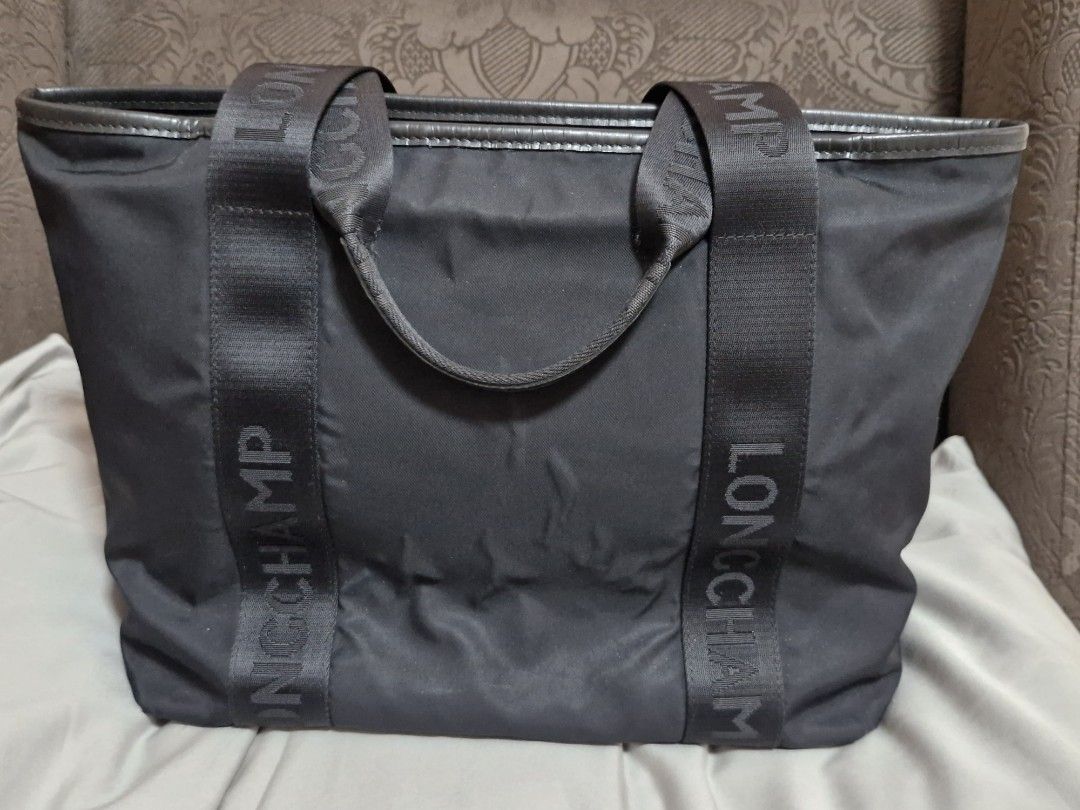 Longchamp Tote Bag Black Nylon Leather Trim (Category: Luxury Bags & Wallets) located in Quezon City. Submitted by mglf1983 (Listing ID 1445496439, Image 2). Description: - Authentic Black Longchamp Tote Bag - Durable Nylon Material with Leather Trim - Iconic Longchamp Logo on Straps - Spacious Interior for Everyday Use - Secure Front Pocket with Button Closure.