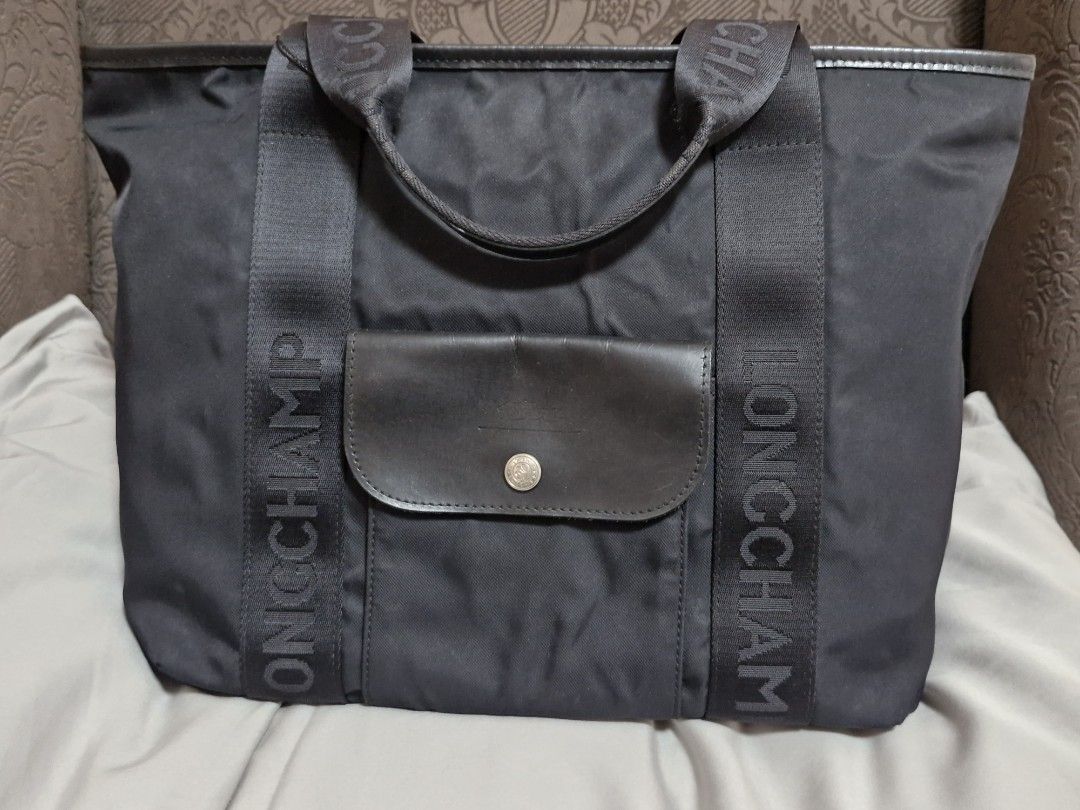 Longchamp Tote Bag Black Nylon Leather Trim (Category: Luxury Bags & Wallets) located in Quezon City. Submitted by mglf1983 (Listing ID 1445496439, Image 1). Description: - Authentic Black Longchamp Tote Bag - Durable Nylon Material with Leather Trim - Iconic Longchamp Logo on Straps - Spacious Interior for Everyday Use - Secure Front Pocket with Button Closure.