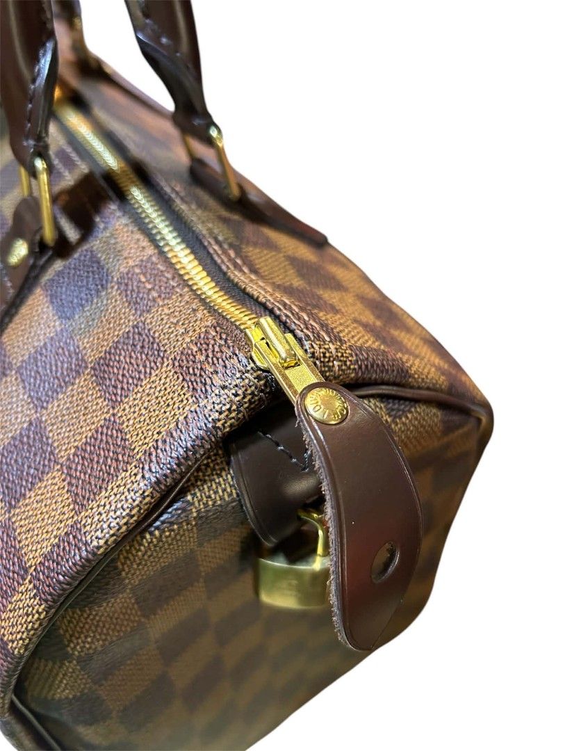 Louis Vuitton Speedy Damier Ebene Canvas Handbag (Category: Luxury Bags & Wallets) located in Dagupan City. Submitted by jefferson85509 (Listing ID 1445563748, Image 3). Description: - Authentic Louis Vuitton Speedy bag - Damier Ebene canvas - Iconic design with leather handles and trim - Secure zipper closure with padlock - Comes with original dust bag - Timeless piece for everyday use and travel.