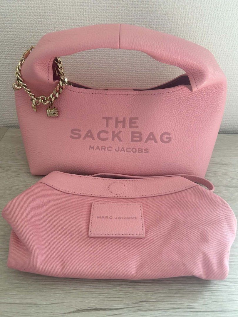 Marc Jacobs The Sack Bag Pink Leather (Category: Luxury Bags & Wallets) located in Manila. Submitted by stefandraboutique (Listing ID 1445509019, Image 3). Description: - Authentic Pink Marc Jacobs The Sack Bag - Textured leather for a premium feel - Elegant gold chain detail with charming accents - Includes a convenient detachable pouch - Spacious interior, ideal for daily essentials - A stylish and practical everyday handbag.
