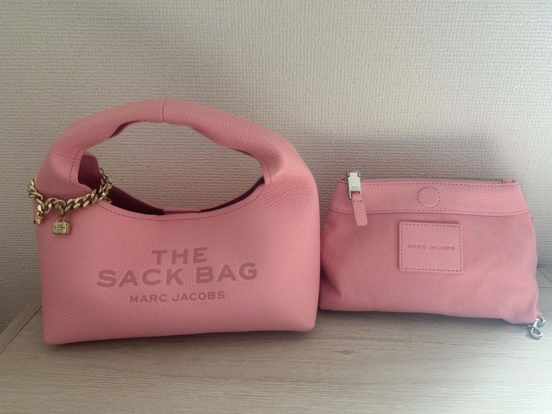 Marc Jacobs The Sack Bag Pink Leather (Category: Luxury Bags & Wallets) located in Manila. Submitted by stefandraboutique (Listing ID 1445509019, Image 2). Description: - Authentic Pink Marc Jacobs The Sack Bag - Textured leather for a premium feel - Elegant gold chain detail with charming accents - Includes a convenient detachable pouch - Spacious interior, ideal for daily essentials - A stylish and practical everyday handbag.