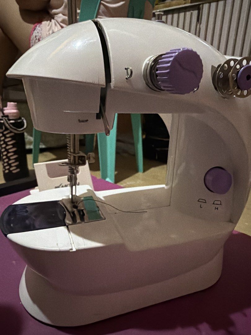 Mini Portable Sewing Machine White Purple (Category: Craft Supplies & Tools) located in Paranaque City. Submitted by gladysequi24017 (Listing ID 1445555679, Image 3). Description: - Compact sewing machine - Ideal for quick fixes and small projects - Easy to operate - Two speed settings (L/H) - Includes power cord - Tested and working.