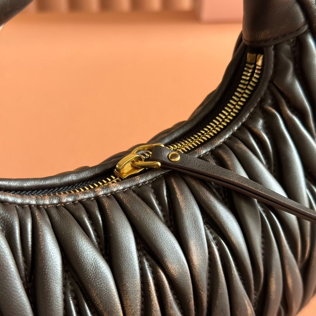 Miu Miu Black Matelassé Mini Bag (Category: Luxury Bags & Wallets) located in Muntinlupa City. Submitted by sunstoneglow5116882 (Listing ID 1445496191, Image 2). Description: - Authentic Miu Miu mini bag - Signature matelassé leather - Top handle - Detachable shoulder strap - Gold-tone hardware - Includes dust bag and box - Ideal for evenings or adding chicness to any outfit.