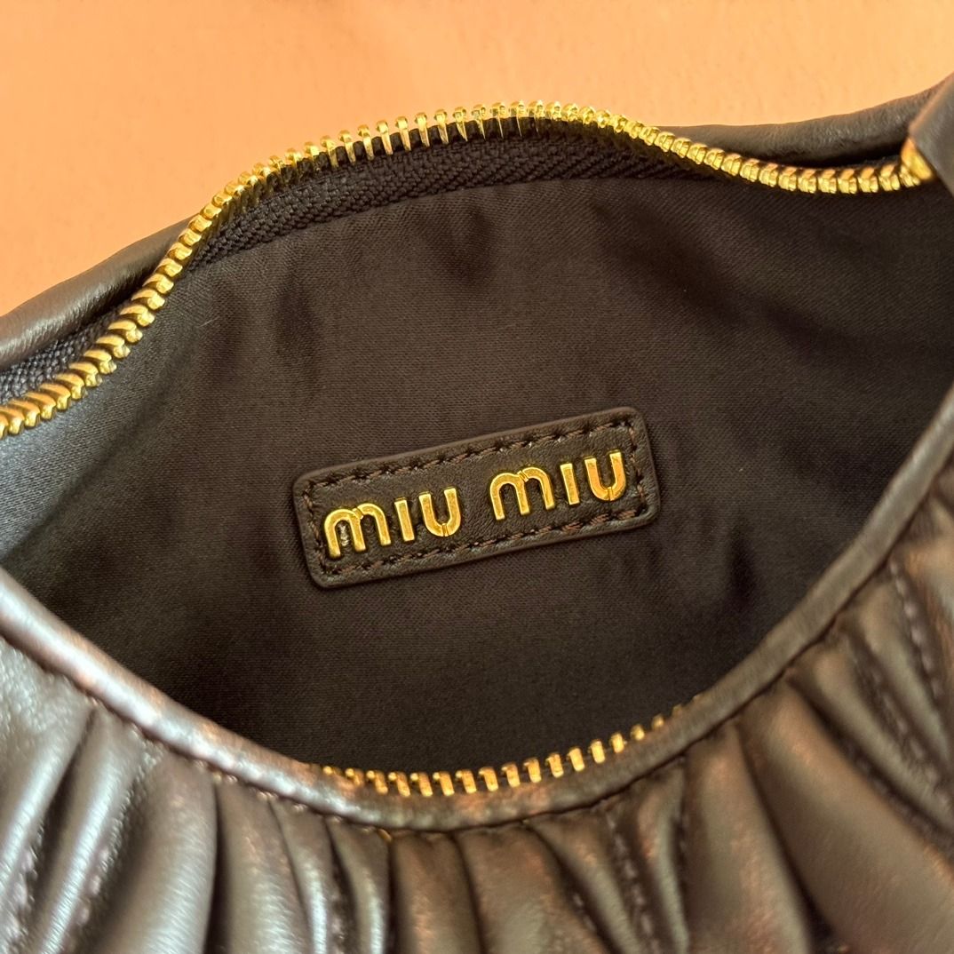Miu Miu Black Matelassé Mini Bag (Category: Luxury Bags & Wallets) located in Muntinlupa City. Submitted by sunstoneglow5116882 (Listing ID 1445496191, Image 3). Description: - Authentic Miu Miu mini bag - Signature matelassé leather - Top handle - Detachable shoulder strap - Gold-tone hardware - Includes dust bag and box - Ideal for evenings or adding chicness to any outfit.