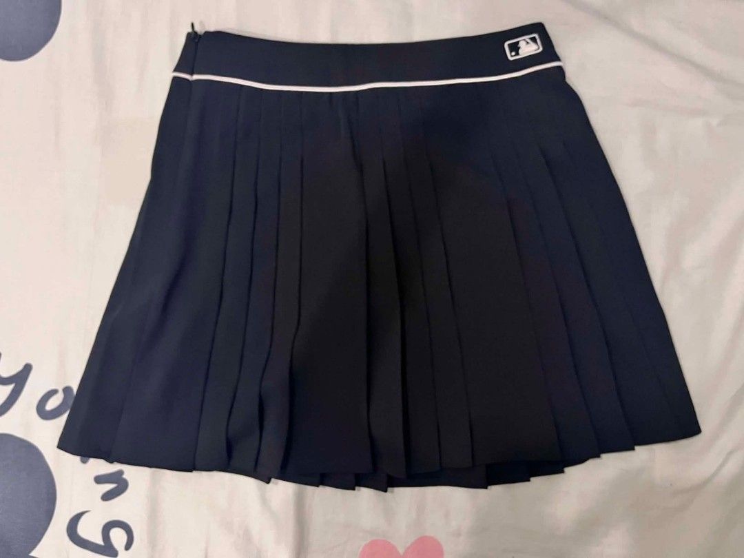 MLB Pleated Skirt Black XS (Category: Skirts) located in Taytay. Submitted by danielprad78683 (Listing ID 1445493627, Image 2). Description: - Black pleated skirt from MLB - Features white piping detail - Embroidered MLB logo - Size: XS - Genuine merchandise - Ideal for sporty or casual outfits - Pairs well with t-shirts and hoodies.