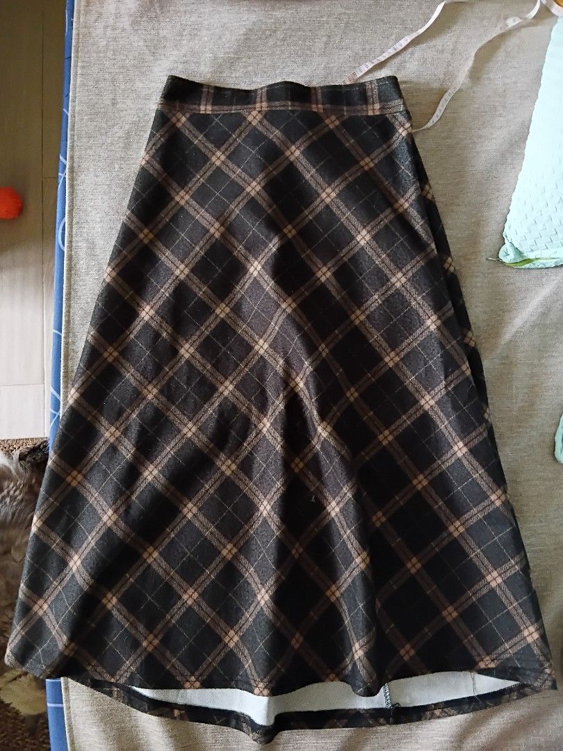 Olive Green Plaid A-line Skirt (Category: Skirts) located in Los Banos. Submitted by alyanizuu (Listing ID 1445488169, Image 1). Description: - Classic brown green and tan plaid pattern - Flattering A-line cut - Size: M - Versatile for casual or dressed-up looks.