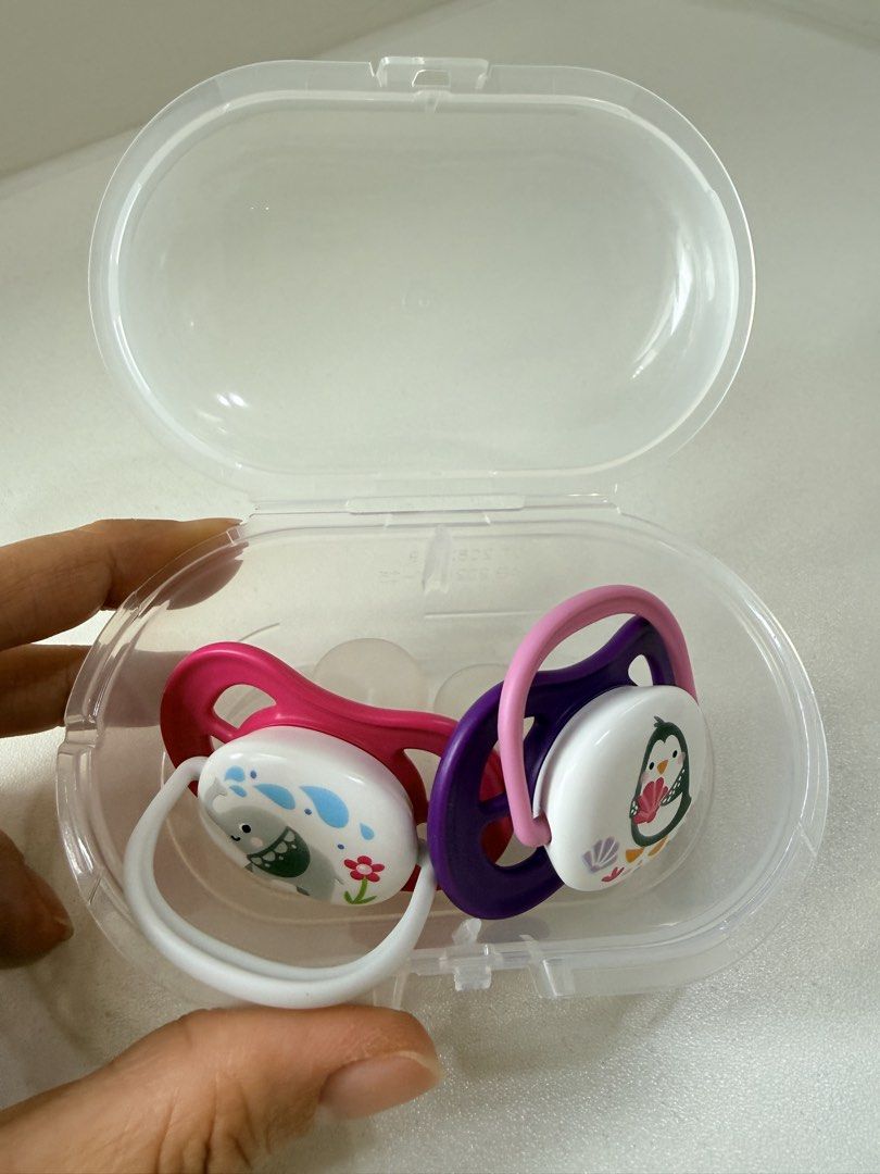 Philips Avent Pacifiers with Case (Category: Soothers & Pacifiers) located in Caloocan City. Submitted by shop.ginny (Listing ID 1445585006, Image 2). Description: - Set of 4 Philips Avent pacifiers - Includes a clear travel case for hygiene and organization - Two pacifiers feature adorable animal designs: a whale and a penguin - Two pacifiers are solid colors: pink and purple - Perfect for keeping your baby's pacifiers clean and accessible on th