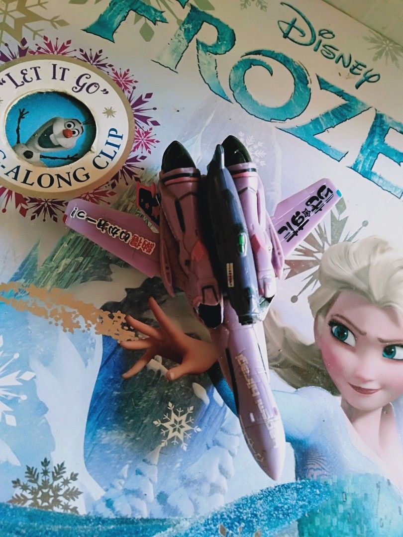 Pink Anime Decal Toy Airplane (Category: Vehicle & Diecast Models) located in Davao. Submitted by bravemoon_556cd5 (Listing ID 1445446537, Image 2). Description: - Cool pink toy airplane - Features anime decals - Unique design with Japanese text on wings - Ideal for collectors or display - (Note: Disney Frozen background is a separate toy).