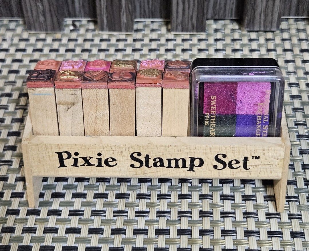 Pixie Stamp Set with Ink Pad (Category: Craft Supplies & Tools) located in Rizal. Submitted by cherry_garcia (Listing ID 1445536342, Image 2). Description: - Pixie Stamp Set with wooden holder - Features various designs like hearts and flowers - Includes 'Personal Stamp Exchange' ink pad - 4 ink colors: pink, purple, blue, and green - Ideal for crafting and scrapbooking projects.