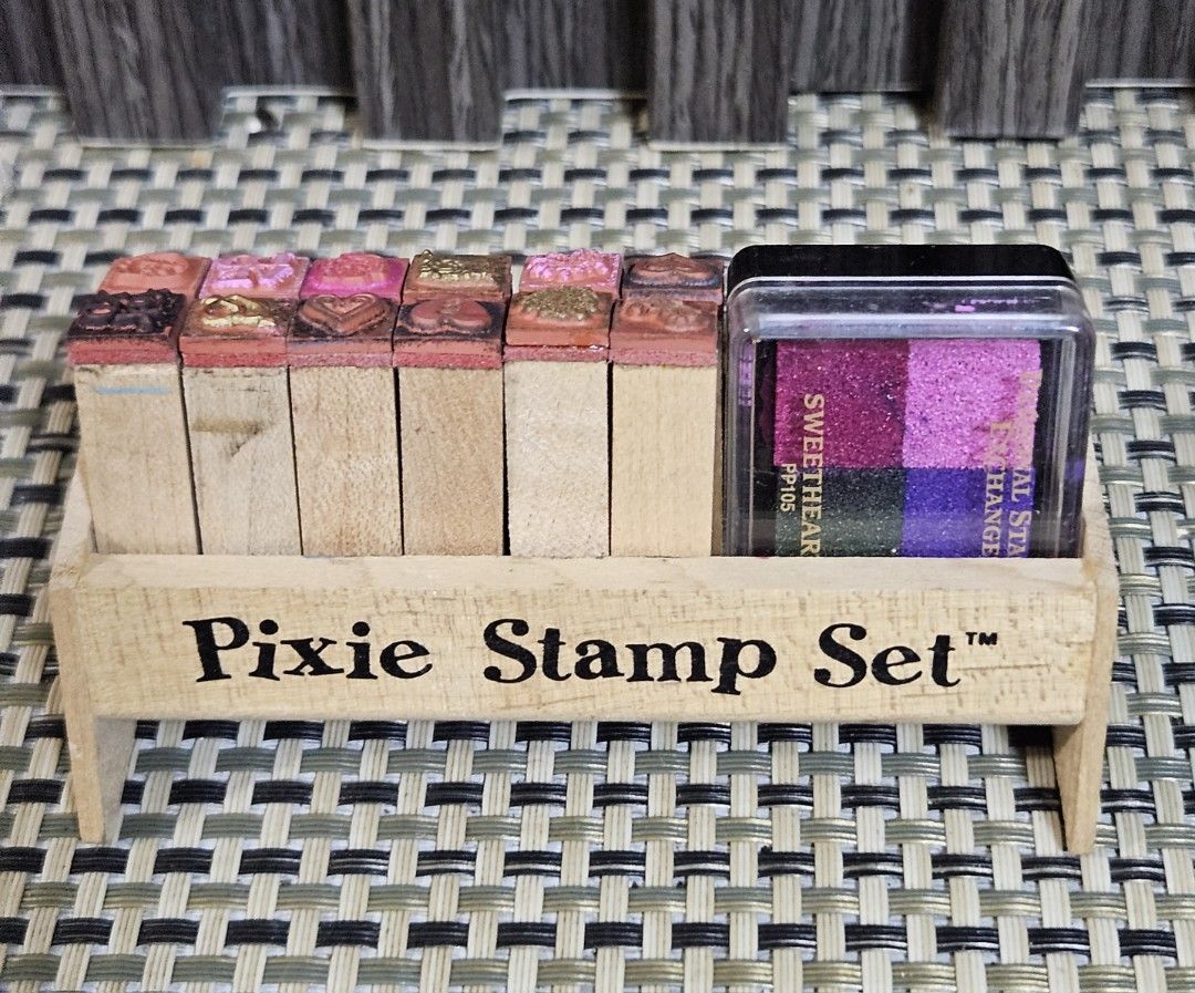 Pixie Stamp Set with Ink Pad (Category: Craft Supplies & Tools) located in Rizal. Submitted by cherry_garcia (Listing ID 1445536342, Image 1). Description: - Pixie Stamp Set with wooden holder - Features various designs like hearts and flowers - Includes 'Personal Stamp Exchange' ink pad - 4 ink colors: pink, purple, blue, and green - Ideal for crafting and scrapbooking projects.