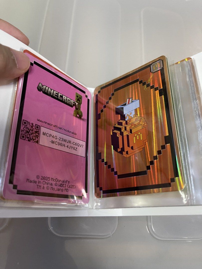 Pokemon Trading Card Binder with Minecraft Cards (Category: Raw Singles) located in Quezon City. Submitted by jaedenry0228 (Listing ID 1445451325, Image 3). Description: - Pokemon trading card binder featuring a cool Dialga and Palkia cover. - Comes with several Minecraft trading cards. - Cards are from McDonald's and have a shiny, holographic finish. - Ideal for collectors looking to add to their collection..