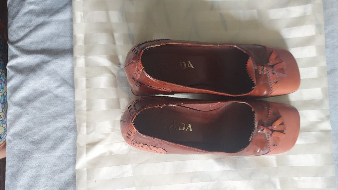 Prada Leather Tassel Block Heels Size 37.5 (Category: Heels) located in Cavite. Submitted by bonita2230 (Listing ID 1445469465, Image 3). Description: - Brand: Prada - Color: Rich Brown & Orange Leather - Design: Square toe with tassel detail - Heel: Stacked block heel - Accents: Wingtip detailing on sides - Origin: Made in Italy - Size: 37.5.