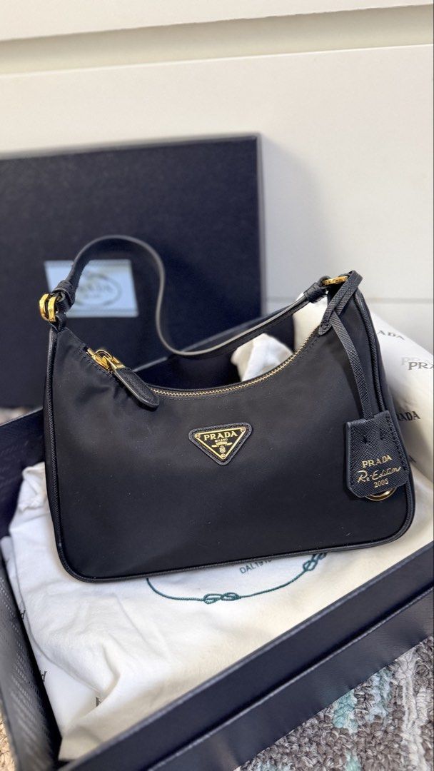Prada Re-Edition 2005 Nylon Bag Black (Category: Luxury Bags & Wallets) located in Las Pinas. Submitted by lanasmom (Listing ID 1445483138, Image 2). Description: - gifted, didn’t check for authenticity - as is where is - inclusions in the photo.