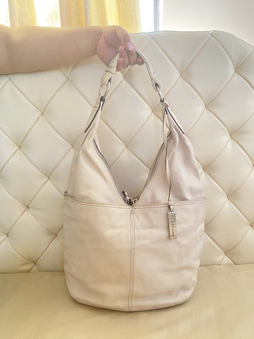 🕊️Repriced! Rabeanco Cream Leather Hobo bag (Category: Shoulder Bags) located in San Pablo. Submitted by restoredchic (Listing ID 1445558114, Image 1). Description: Rabeanco Cream Leather Hobo bag Key Features * Design: It features a soft-structured, draped hobo shape with two prominent half-panel front slip pockets. * Hardware: The shoulder strap is connected by distinctive polished metal rings. * Closure: It typically has a top zipped closure 