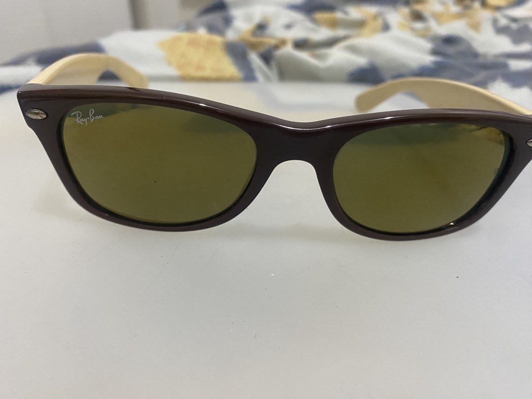 Ray-Ban Wayfarer Sunglasses Brown Frame (Category: Sunglasses & Eyewear) located in Quezon City. Submitted by iam3871 (Listing ID 1445579139, Image 2). Description: - Classic Ray-Ban Wayfarer sunglasses - Brown frame with light brown arms - Tinted lenses - Perfect for everyday wear - Features Ray-Ban logo on the side - A stylish accessory.
