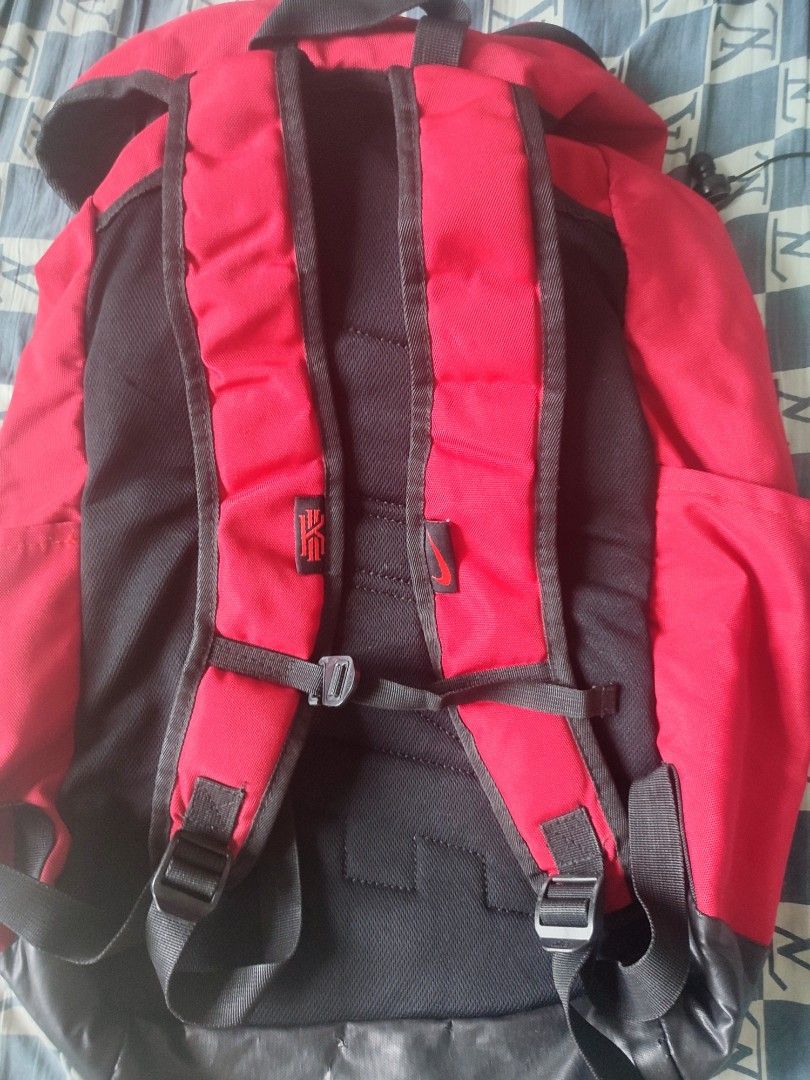 Red Nike Backpack with Kyrie Logo (Category: Backpacks) located in Sorsogon. Submitted by sergioslyughsome (Listing ID 1445427026, Image 2). Description: - Red Nike backpack featuring the iconic Kyrie logo on the top flap. - Stylish black accents and comfortable adjustable straps. - Multiple pockets for organized storage. - Durable material built to last. - Ideal for school, gym, or everyday adventures..