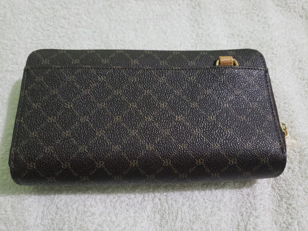 RIONI Leather Dual Zip Wallet with Strap (Category: Luxury Bags & Wallets) located in Navotas City. Submitted by miloklo (Listing ID 1445534700, Image 3). Description: - Authentic RIONI wallet with signature monogram print. - Tan leather accent band on the front. - Secure zipper closure. - Interior features multiple card slots and a clear ID window. - Comes with a detachable crossbody strap. - Almost new with original tags..