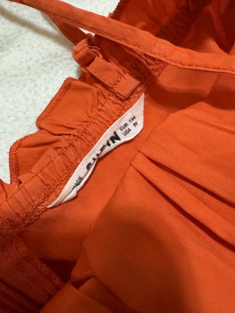 SHEIN Orange Button Front Ruffle Strap Dress Size US 9Y (Category: Babies & Kids Fashion) located in Mandaluyong City. Submitted by toront0427 (Listing ID 1445541579, Image 3). Description: - Cute orange dress from SHEIN Size US9Y - Features a ruffled neckline - Adjustable straps for a perfect fit - Button front detail - Flared skirt design - Ideal for summer days - Easy to wear and style Booking and delivery fee c/o buyer for pick up at Avida Ce