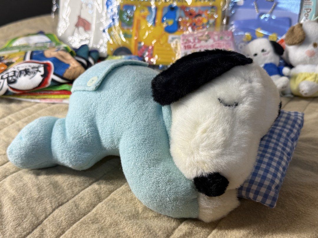Sleeping Snoopy Dog Plush Toy with Pillow (Category: Plushies & Soft Toys) located in Valenzuela. Submitted by missp22 (Listing ID 1445489752, Image 2). Description: - Adorable plush toy resembling Snoopy, the sleeping dog. - Comes dressed in cute light blue pajamas. - Includes a small checkered pillow for extra charm. - Made with soft and cuddly material, perfect for hugs. - Ideal for collectors or as a delightful decor piece. - Packaging is inc