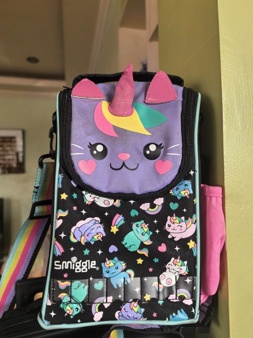Smiggle Unicorn Cat Trolley (Category: Babies & Kids Fashion) located in Candaba. Submitted by bibiboop (Listing ID 1445453795, Image 2). Description: - Adorable Smiggle backpack featuring a unique unicorn cat design. - Decorated with playful rainbows, stars, and clouds. - Handle shows some wear, as pictured. - Ideal for school, daycare, or everyday adventures..