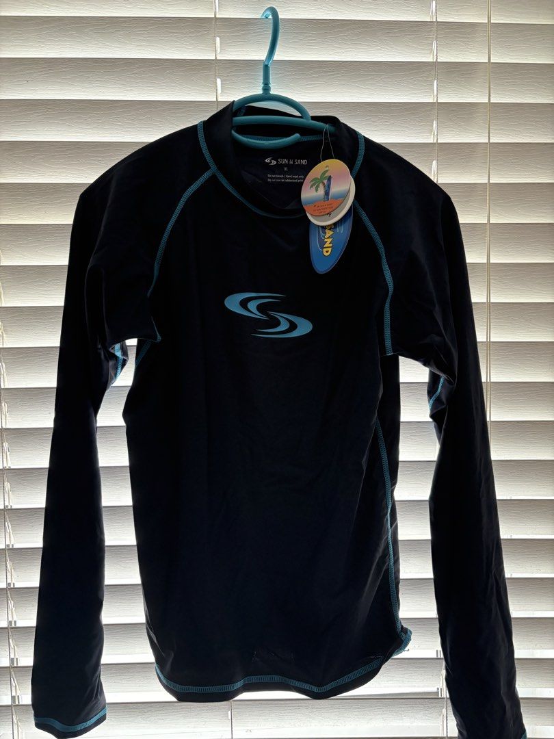 Sun & Sand Long Sleeve Rash Guard Top (Category: Rash guard) located in Antipolo. Submitted by _alyyy_ (Listing ID 1445460564, Image 2). Description: - one for 350, 600 only for bundle Brand: Sun & Sand - Color: Black - Style: Long sleeve rash guard - Features: Pink contrast stitching, Sun & Sand logo on front - Use: Ideal for swimming and sun protection - Condition: Brand new with tag still attached.