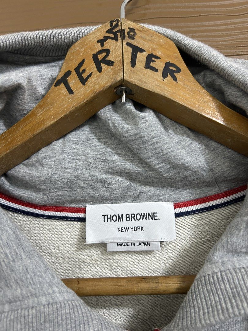 Thom Browne Grey Zip-Up Hoodie Size 3 (Category: Coats, Jackets and Outerwear) located in Manila. Submitted by andotputla37237 (Listing ID 1445555445, Image 2). Description: - Grey zip-up hoodie from Thom Browne - Signature four-stripe detail on the sleeve - Made in Japan - Size 3 - Good quality, substantial material - Perfect for casual wear.