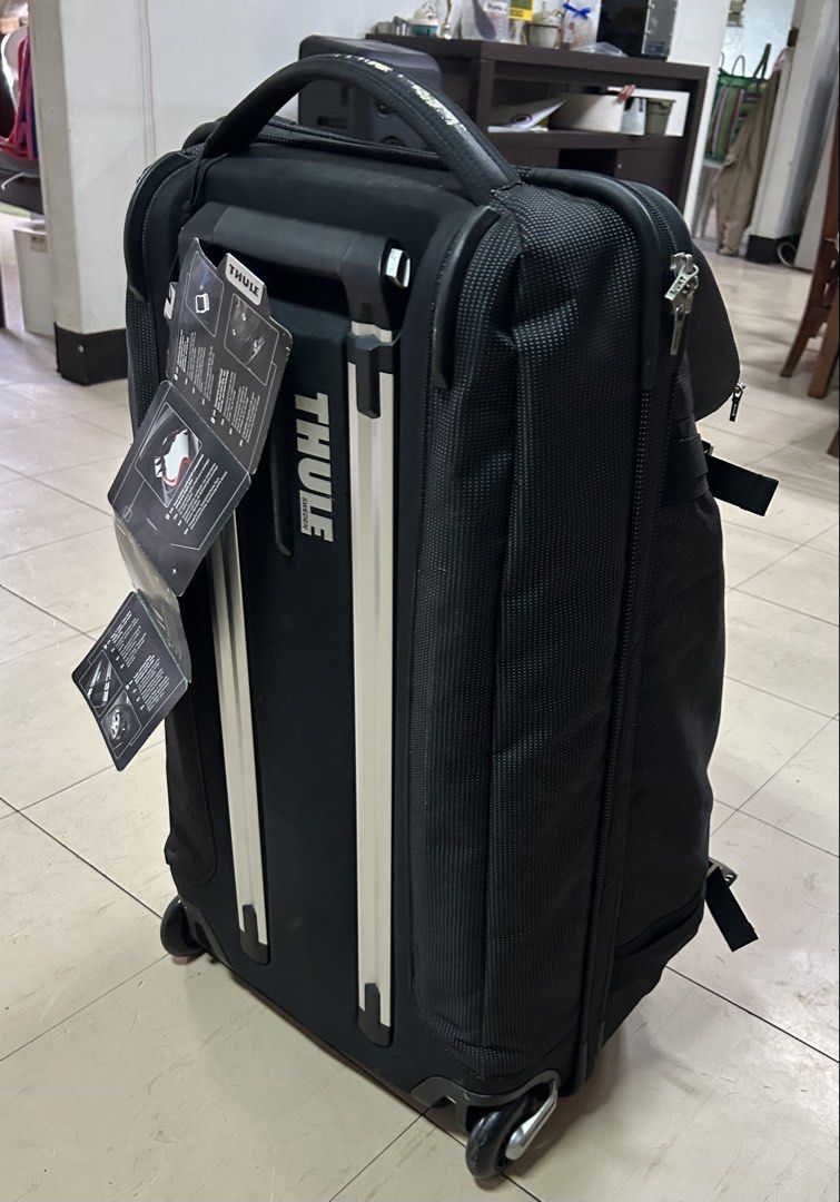 Thule Black Rolling Luggage Bag (Category: Luggage) located in Quezon City. Submitted by rottiemom (Listing ID 1445424509, Image 3). Description: - Black Thule rolling luggage - Retractable handle and wheels for easy transport - Multiple compartments for organization - Shows some wear on handle - Still very functional for travel Bought for 17k, bought then stored, never pa nagamit. Handle nagbakbak na pero usable padin Zipper natanggal na ung blu