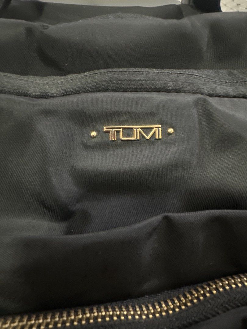 Tumi Black Nylon Rolling Carry-On Trolley Bag (Category: Luggage) located in Cainta. Submitted by shopbyyna (Listing ID 1445513544, Image 2). Description: - Stylish black Tumi trolley bag - Made from durable nylon with elegant gold hardware - Multiple interior compartments for excellent organization - Features a retractable handle and smooth-rolling wheels for effortless transport - Ideal for both leisure travel and business trips - Offers ample 
