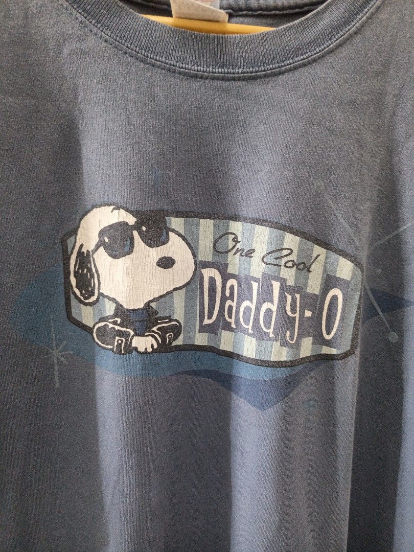 Vintage Snoopy Peanuts Shirt (Category: Tshirts & Polo Shirts ) located in Cavite. Submitted by neiljaymol16885 (Listing ID 1445507550, Image 2). Description: - Blue t-shirt featuring Snoopy in sunglasses with "One Cool Daddy-O" text. - Officially licensed by Peanuts. - Made by Gildan, Ultra Cotton heavyweight fabric. - Size: Large. - Ideal for Snoopy enthusiasts and dads. -Dimes : 21/29.5.