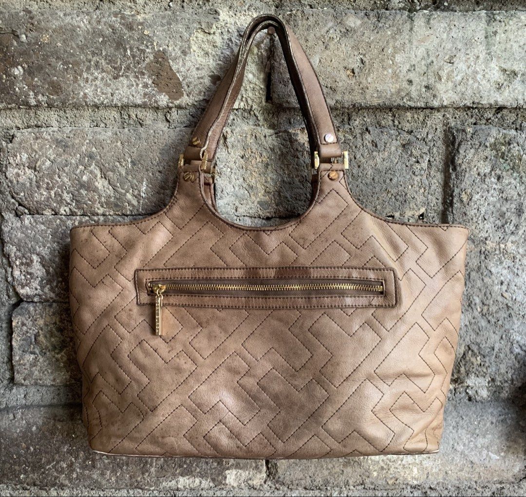 Vintage Tory Burch Shoulder Bag (Category: Shoulder Bags) located in Marikina City. Submitted by arrveefm (Listing ID 1445428136, Image 2). Description: Used Vintage Tory Burch Brown Leather Tote Bag (Used as Kili-kili Bag) Crafted from soft, supple leather in a versatile neutral brown shade. It features a distinctive all-over geometric logo-stitched pattern, showcasing the brand’s signature design in a subtle yet sophisticated way. Php 1,500.00 