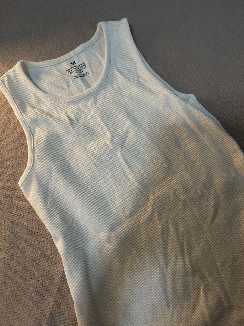 white basic tanktop (Category: Sleeveless) located in Singapore. Submitted by sarahc20 (Listing ID 1445579033, Image 2). Description: Closet Clear-Out! Everything Must Go! - Reference: I’m 168cm / 52kg , and this fits me well - Fits S - Fast replies & meet-ups in SG! - Can negotiate if buy more than 3 pcs of clothing - Stretchy DM for more details! 💗.