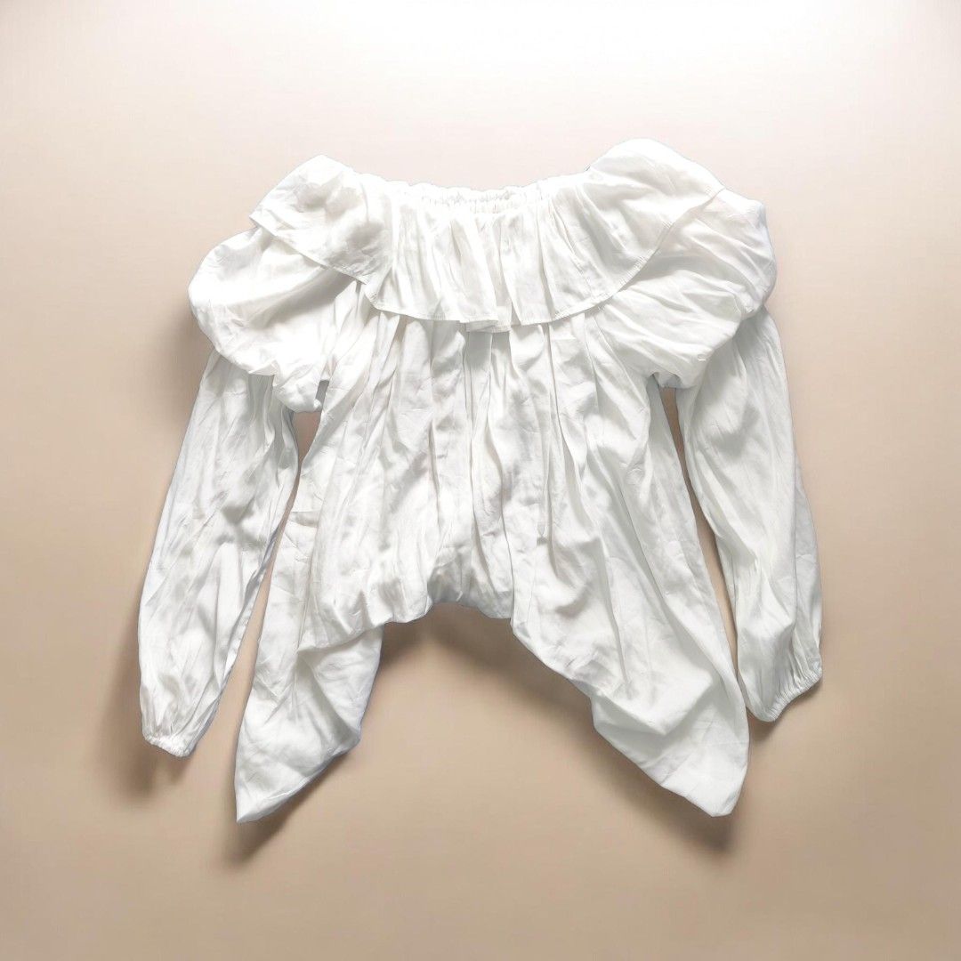 White Off-Shoulder Ruffle Blouse with Puffy Sleeves (Category: Blouses) located in Taguig. Submitted by deyerreC2020 (Listing ID 1445457801, Image 3). Description: sale blouse Chic white off-shoulder top with ruffles and puffy sleeves. Features an asymmetrical hem. Perfect for a standout outfit! Full size on photo Preloved off shoulder tops Nice ruffles loose style L on tag Like new tops Can wear up to XL w/ under lining cotton-polyester viscose 