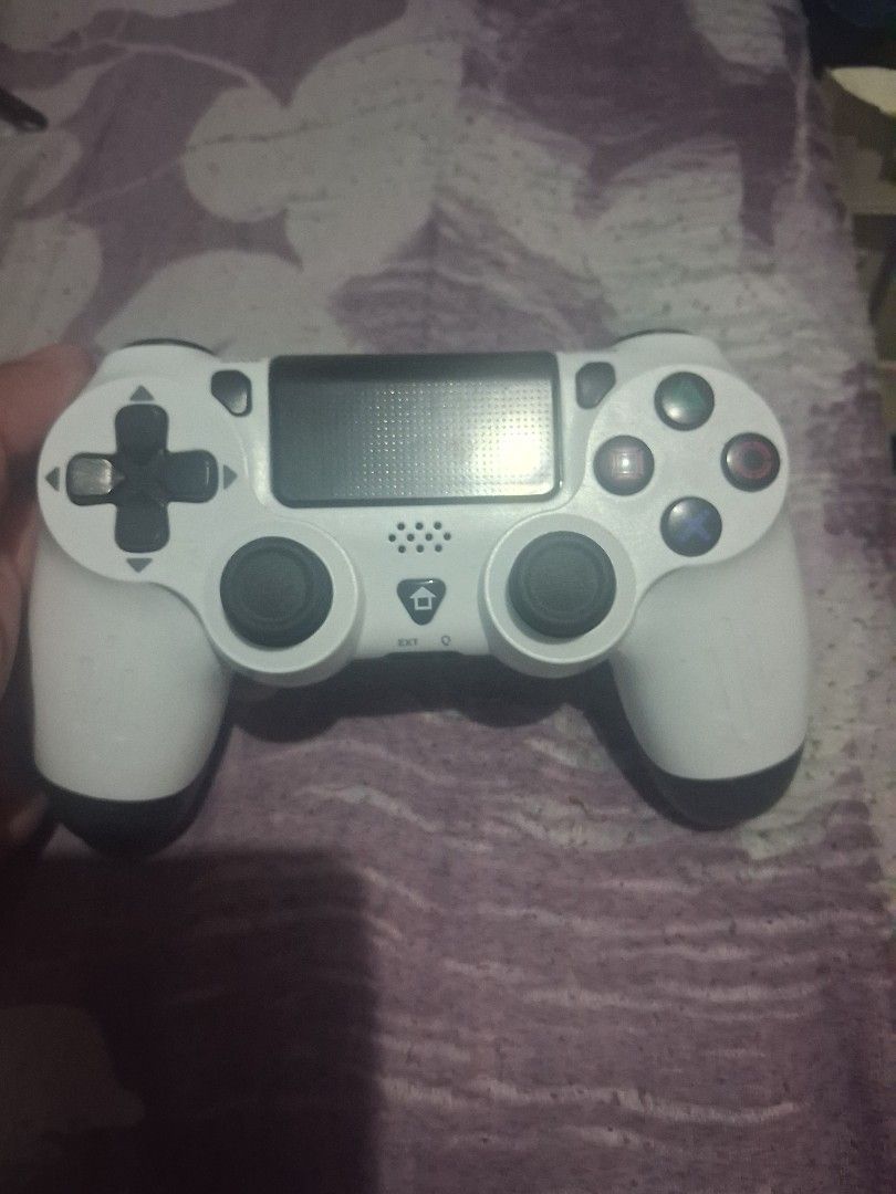 White PlayStation 4 DualShock 4 Controller (Category: Controllers) located in Quezon City. Submitted by obet89 (Listing ID 1445422465, Image 1). Description: - White PS4 Controller - Fully functional and works well - Minor cosmetic scuffs from normal use - All buttons and joysticks are responsive - Ideal for gaming sessions - Ready for a new owner.