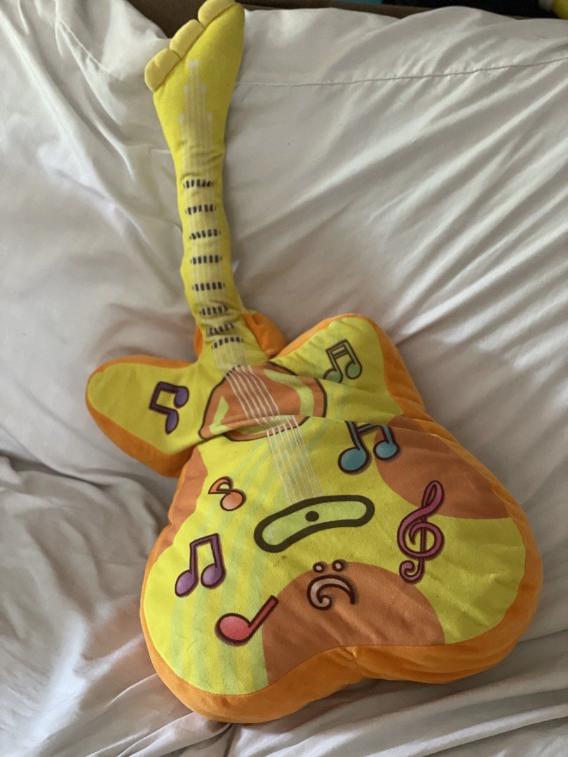 Yellow Guitar Plush Toy with Music Notes (Category: Musical Instruments) located in Cainta. Submitted by anne_garagesale (Listing ID 1445454131, Image 1). Description: - Adorable guitar-shaped plush toy - Bright yellow with vibrant orange accents - Decorated with charming musical notes and symbols - Super soft and huggable material - Ideal gift for kids or music enthusiasts - Adds a fun decorative touch to any room.