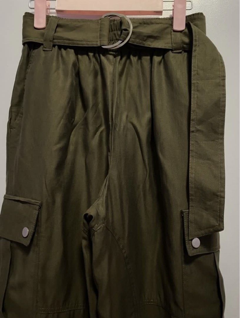 ZARA Belted Cargo Pants Olive Green (Category: Other Bottoms) located in Bacoor. Submitted by _myprelovedcloset (Listing ID 1445516767, Image 2). Description: - ZARA Olive Green Cargo Pants - Size S (EUR 36, USA 4, MEX 26) - Belted waist with silver buckle - Comfortable elasticated waistband - Two side pockets with button closure - Adjustable tie detail at the hem.