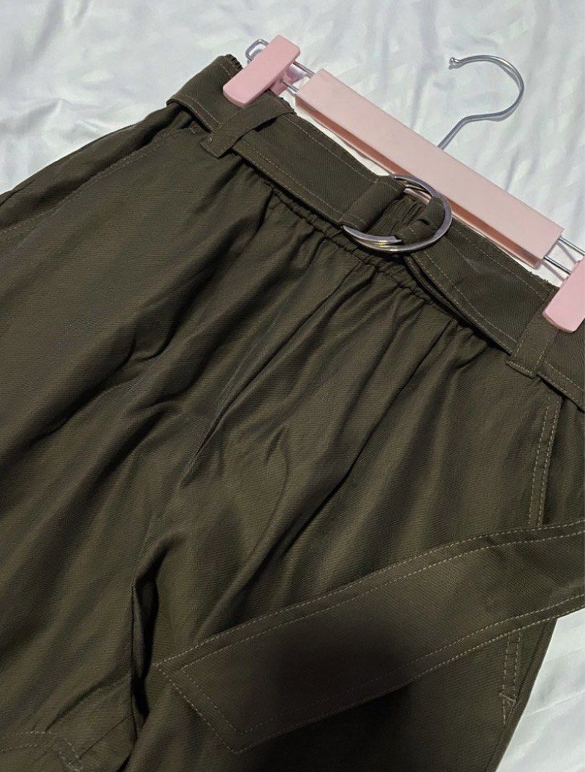 ZARA Belted Cargo Pants Olive Green (Category: Other Bottoms) located in Bacoor. Submitted by _myprelovedcloset (Listing ID 1445516767, Image 1). Description: - ZARA Olive Green Cargo Pants - Size S (EUR 36, USA 4, MEX 26) - Belted waist with silver buckle - Comfortable elasticated waistband - Two side pockets with button closure - Adjustable tie detail at the hem.