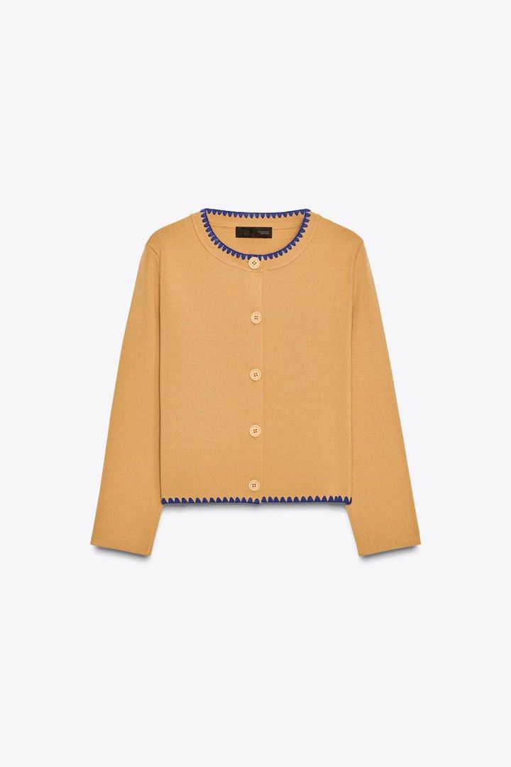 Zara Camel Cardigan with Blue Trim (Category: Others Tops) located in Quezon City. Submitted by biverse.shop (Listing ID 1445602959, Image 2). Description: - Cute camel colored cardigan - Features blue zigzag trim along neckline and hem - Button front closure - Great for pairing with jeans - Ideal for layering.