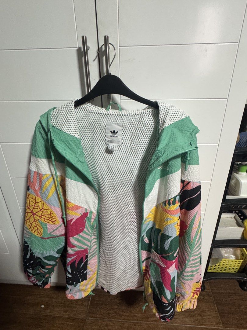 Adidas Tropical Print Windbreaker Jacket (Category: Coats, Jackets and Outerwear) located in Calumpit. Submitted by scdecluttering (Listing ID 1445654807, Image 2). Description: - Vibrant tropical print Adidas windbreaker - Stylish mint green and white color blocking - Comfortable mesh lining inside - Adjustable drawstrings on hood and hem - Ideal for casual outings or light exercise.
