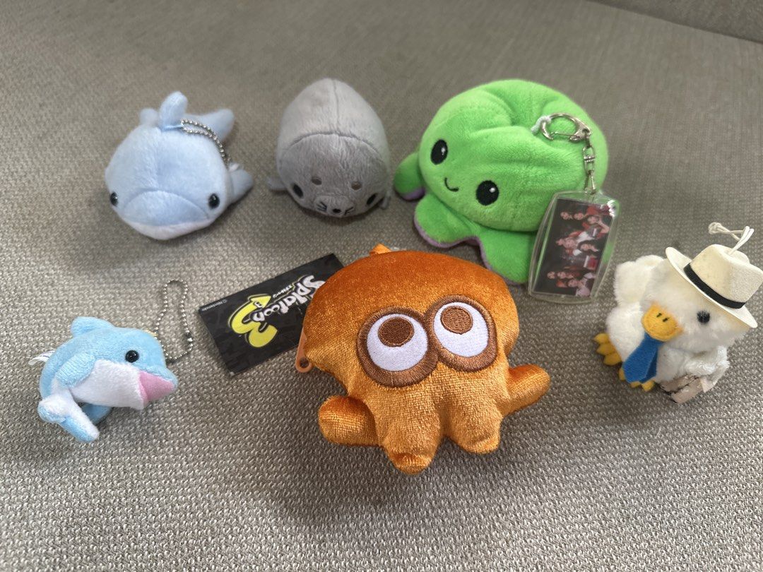 Assorted Plushie Keychains - Splatoon, Octopus, Dolphin, Duck (Category: Plushies & Soft Toys) located in Cainta. Submitted by shopbyyna (Listing ID 1445634234, Image 1). Description: - Adorable plushie keychain collection. - Includes: Splatoon tag, orange octopus, green octopus, two dolphins, a seal, and a duck wearing a hat. - All plushies come with attached keychains. - Ideal for decorating bags, backpacks, or as small, charming gifts..