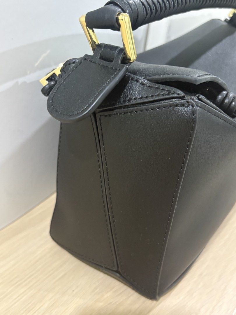 Authentic Loewe puzzle bag in black with braided handles (Category: Luxury Bags & Wallets) located in Manila. Submitted by pursonalshopper (Listing ID 1445706876, Image 3). Description: Loewe Small Puzzle Bag pre loved. COMPLETE INCLUSIONS: ✅Dustbag ✅Box & paperbag ✅Extra Loewe Sling strap ✅Authenticity card Dimensions: approximately 24 cm (width) x 16.5 cm (height) x 10.5 cm (depth), or about 9.4 x 6.5 x 4.1 inches ✈️WE SHIP NATIONWIDE ✅COD SAME