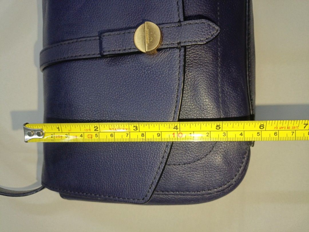 Beanpole Blue Leather Sling Bag (1) (Category: Luxury Bags & Wallets) located in San Pedro. Submitted by elevens_online_thrift_shop (Listing ID 1445762182, Image 3). Description: 📍Brand * **Beanpole:** This is a well-known South Korean premium fashion brand owned by Samsung C&T Fashion Group. The branding is explicitly visible on the gold-tone metal button on the front strap closure , the internal fabric tag , and woven into the interior lining 