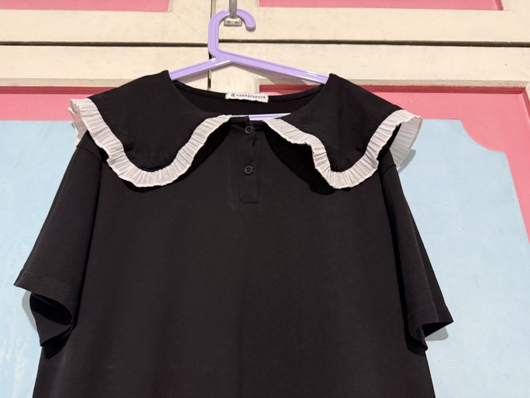 Black Dress with White Peter Pan Collar (Category: Dresses) located in Manila. Submitted by prelovedbyshai_116 (Listing ID 1445631091, Image 2). Description: - Classic black short-sleeved dress - Features a large white pleated Peter Pan collar - Two buttons at the neckline - Simple and versatile design - Great for casual wear or layering - Easy to style up or down -Fits medium.
