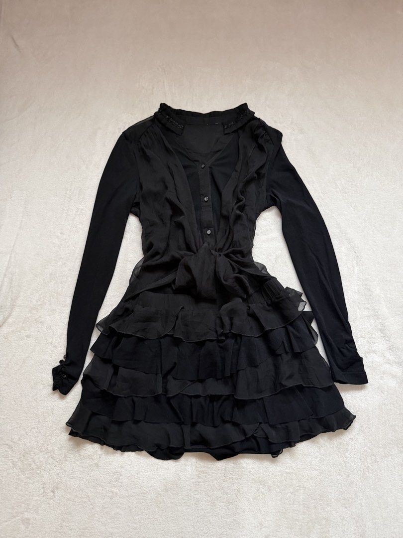 Black Ruffled Chiffon Long Sleeve Dress (Category: Dresses) located in Santa Ana. Submitted by 999h03 (Listing ID 1445773263, Image 1). Description: - Elegant black dress with long sleeves - Features a sheer chiffon overlay with delicate ruffles - Convenient button-up front - Adjustable tie at the waist for a flattering fit - Beautiful beaded detail on the neckline - Ideal for a night out or any special occasion - Offers a chic and sophisticated 