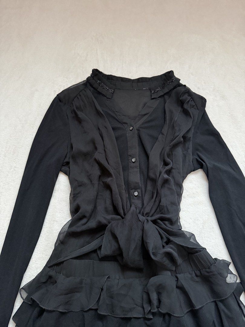 Black Ruffled Chiffon Long Sleeve Dress (Category: Dresses) located in Santa Ana. Submitted by 999h03 (Listing ID 1445773263, Image 2). Description: - Elegant black dress with long sleeves - Features a sheer chiffon overlay with delicate ruffles - Convenient button-up front - Adjustable tie at the waist for a flattering fit - Beautiful beaded detail on the neckline - Ideal for a night out or any special occasion - Offers a chic and sophisticated 