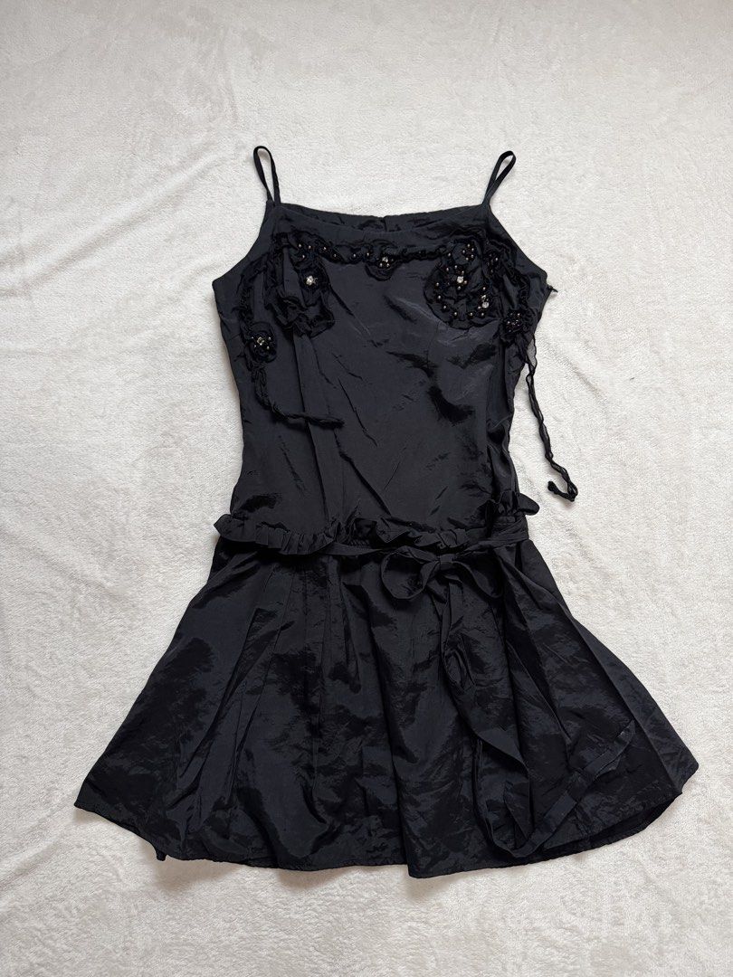 Black Spaghetti Strap Dress with Embellishments (Category: Dresses) located in Santa Ana. Submitted by 999h03 (Listing ID 1445774319, Image 1). Description: - Black spaghetti strap dress - Floral embellishments with beads and pearls on the bodice - Ruffled hemline at the waist - Tie detail on the skirt - Fun and flirty design - Ideal for a night out or special occasion.