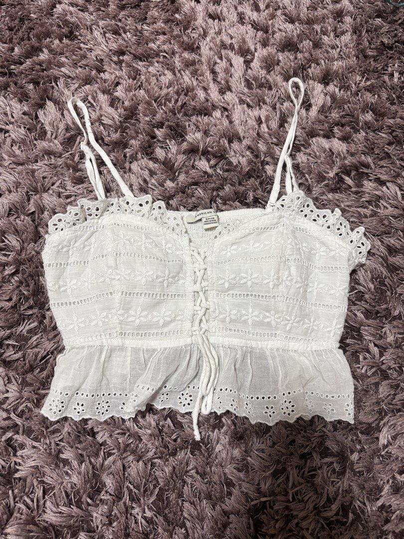 BNWOT American Eagle White Eyelet Tie Top (Category: Sleeveless) located in Quezon City. Submitted by jjccly (Listing ID 1445739564, Image 1). Description: bnwot bought in american eagle store in sm aura - just tried on once size small on tag no flaws/issues no ww *detachable straps! can be worn as a tube.