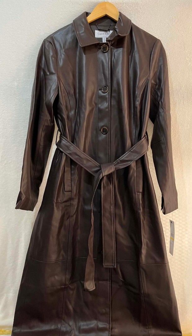 Brown Leather Trench Coat with Belt (Category: Coats, Jackets and Outerwear) located in Quezon City. Submitted by shinereign (Listing ID 1445635795, Image 1). Description: - Long brown leather trench coat - Includes matching belt for a cinched waist - Features a classic collar and button-up front - Versatile styling: dress up or down - Ideal for cooler weather - Made from great quality leather.